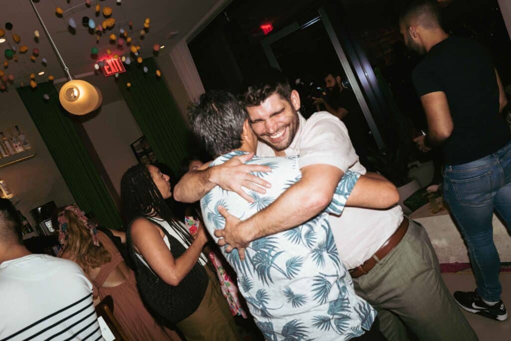 two guys hugging each other