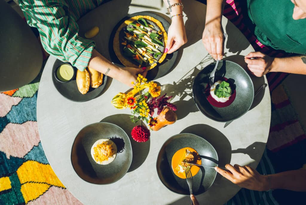Food on a table with people eating